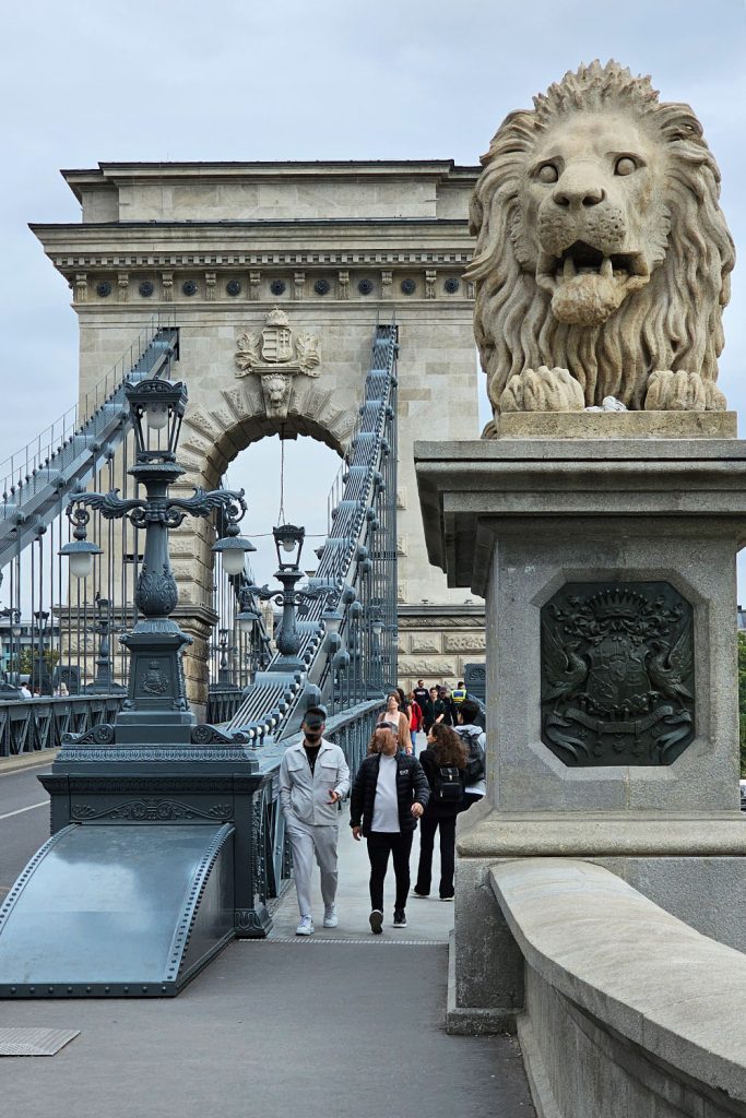 pedestrians walking on the Chain Bridge in Budapest