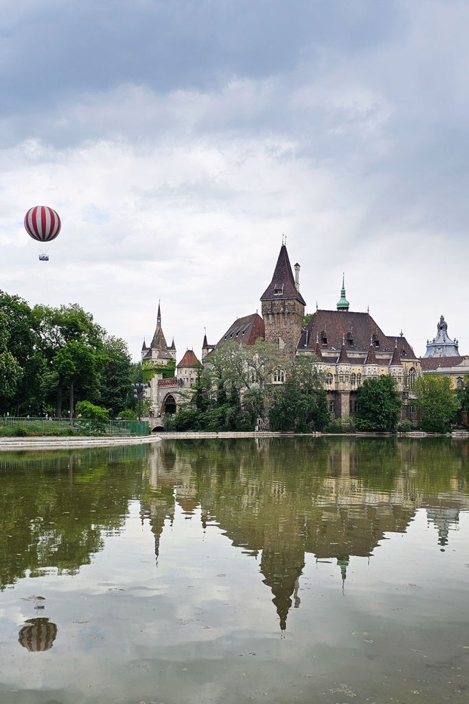 The Vajdahunyad Castle and the BalloonFly hot air balloon next to it over Városligeti Lake