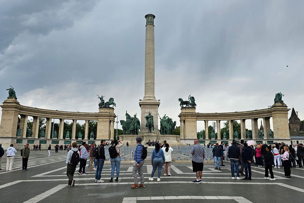 people on Heroes Square on a cloudy, cooler spring day