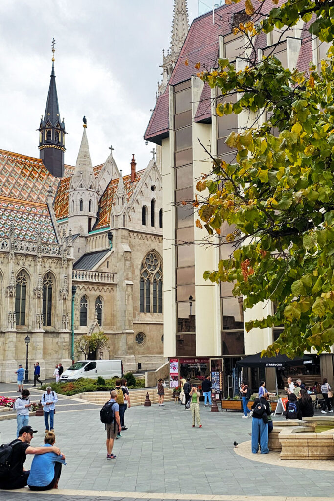 people enjoying a pleasant day near Matthias Church in Budapest on a cloudy but still warm fall day
