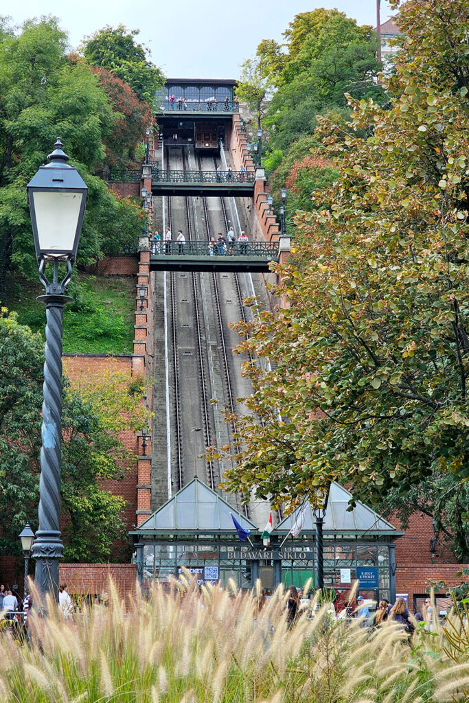The Buda Castle Funicular surrounded by autumn trees on a pleasant fall day