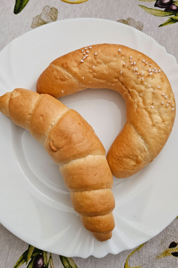 Hungarian breakfast pastries, kifli and salty kifli on a white plate