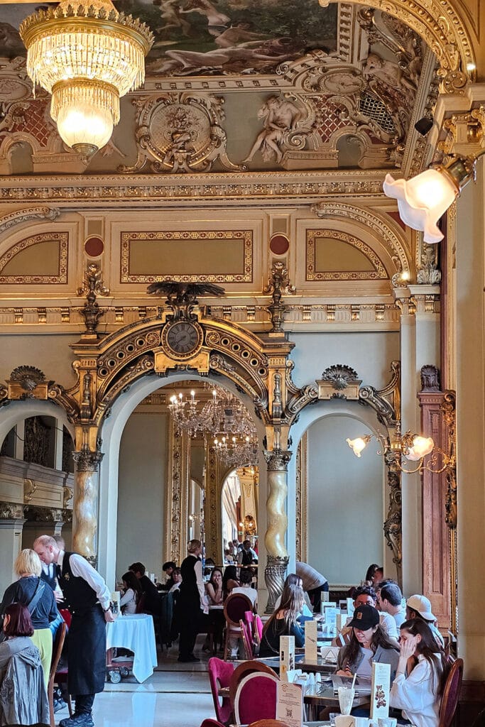people sitting inside New York Cafe in Budapest
