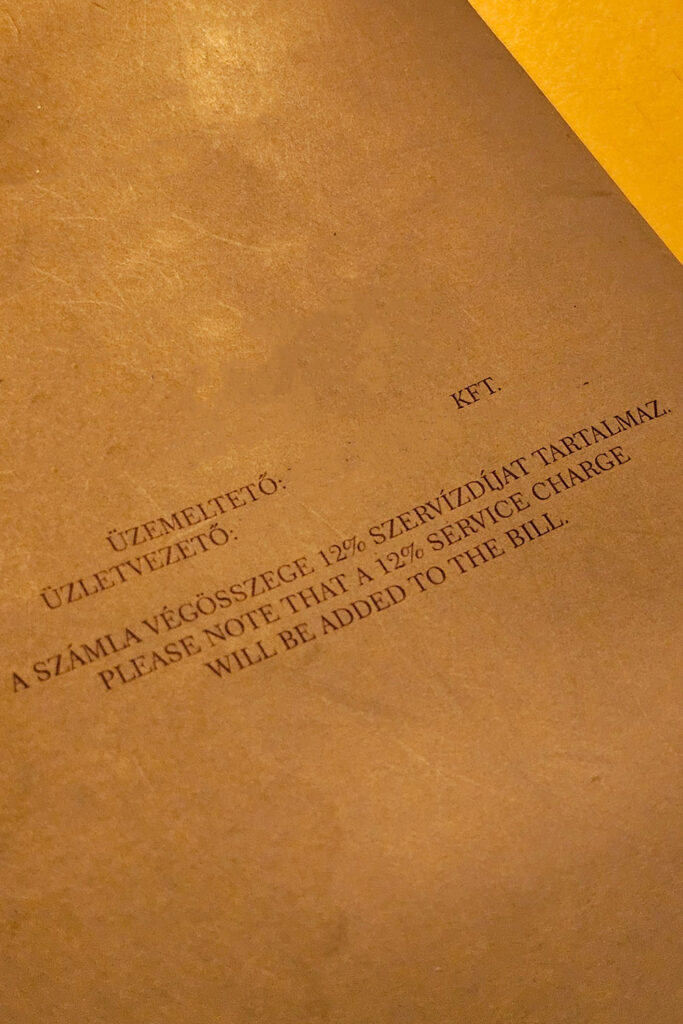 szervizdij stated on a bar's menu in Hungary