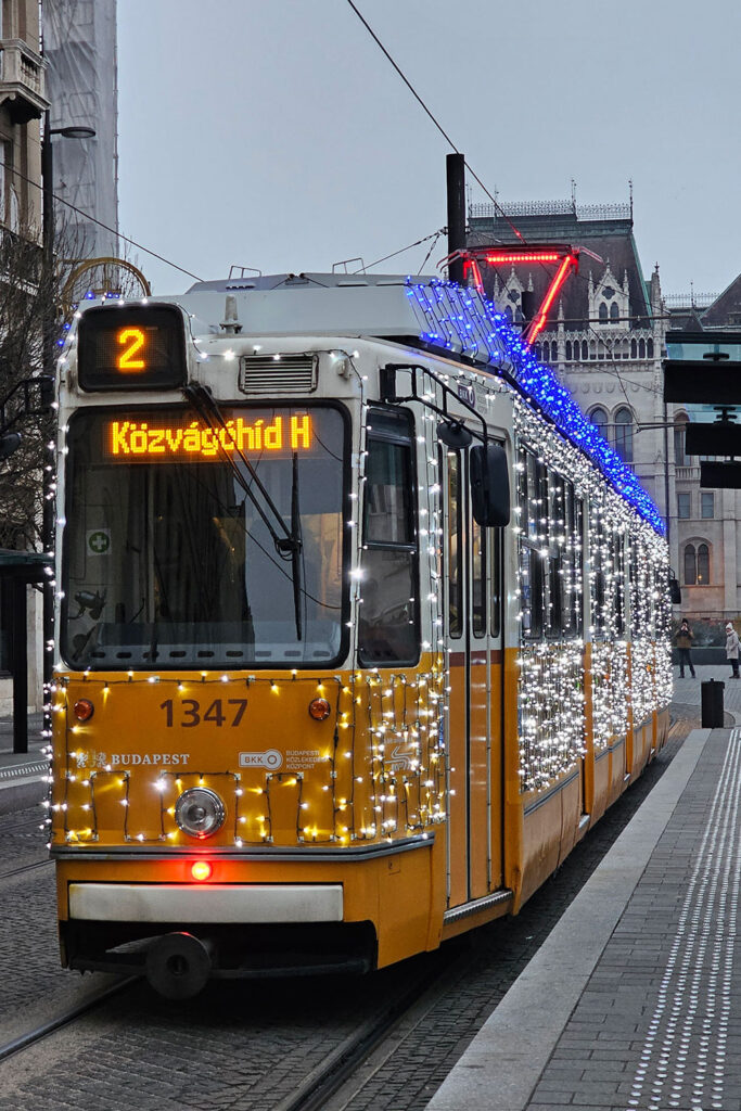 illuminated tram in Budapest near the Parliament during the festive season
