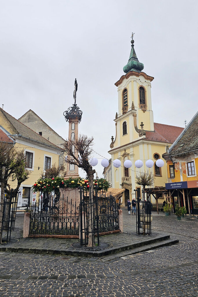 Szentendre's charming town center with church in the background in wintertime, with some festive decoration